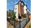 Modern townhome featuring brick accents, black metal railings and a manicured front yard at 5423 S Prince St # B, Littleton, CO 80120