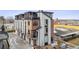 Modern townhome exterior with balconies, brick accents, and sleek architectural design at 5423 S Prince St # B, Littleton, CO 80120