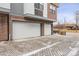 Two-car garage with white doors and a paved driveway, offering ample parking and storage space at 5423 S Prince St # B, Littleton, CO 80120