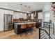 Modern kitchen features stainless steel appliances, brick backsplash, and a center island with bar stool seating at 5423 S Prince St # B, Littleton, CO 80120