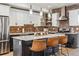 Bright kitchen with white cabinets, a brick backsplash, stainless appliances and island with seating at 5423 S Prince St # B, Littleton, CO 80120