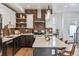 Modern kitchen featuring stainless steel appliances, brick backsplash, and a spacious center island at 5423 S Prince St # B, Littleton, CO 80120