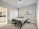 Bedroom featuring neutral walls, carpet, and a sliding closet, next to a bathroom with a black countertop at 4509 Perry St, Denver, CO 80212