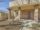 Brick porch featuring brick columns, concrete floor and door with glass window at 4509 Perry St, Denver, CO 80212