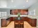 U-shaped kitchen with an island, dark wood cabinets, and stainless steel appliances at 4509 Perry St, Denver, CO 80212