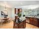 Open kitchen with an island, wood cabinets, stainless steel appliances, and a dining area with a modern chandelier at 4509 Perry St, Denver, CO 80212