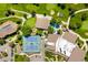 Aerial view highlighting community amenities: tennis courts, pool, golf course, and well-maintained green spaces at 14300 E Marina Dr # 306, Aurora, CO 80014