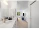 Bright bathroom with white vanity, a quartz countertop, a mirror, and tile flooring at 14300 E Marina Dr # 306, Aurora, CO 80014