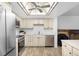 This bright kitchen features stainless steel appliances and tile backsplash at 14300 E Marina Dr # 306, Aurora, CO 80014