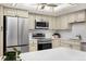 A bright kitchen features stainless steel appliances and solid surface countertops at 14300 E Marina Dr # 306, Aurora, CO 80014