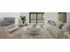 Bright living room features a comfortable sofa, a large television and access to a sunny outdoor balcony at 14300 E Marina Dr # 306, Aurora, CO 80014