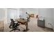 Bright office space featuring a wood desk, black office chair, and views into another room at 14300 E Marina Dr # 306, Aurora, CO 80014