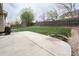 A large backyard featuring a concrete patio, green lawn, and wood fence at 4820 W 125Th Ave, Broomfield, CO 80020