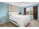 Cozy bedroom featuring a large window, light blue walls, and a white comforter at 4820 W 125Th Ave, Broomfield, CO 80020