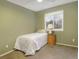Simple bedroom with a twin bed, a nightstand, and a view of trees outside at 4820 W 125Th Ave, Broomfield, CO 80020