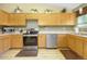 Well-equipped kitchen with modern appliances, wooden cabinetry and ample counter space at 4820 W 125Th Ave, Broomfield, CO 80020