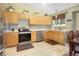 Well-lit kitchen featuring stainless steel appliances, light wood cabinets, and light wood floors at 4820 W 125Th Ave, Broomfield, CO 80020