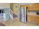 Open kitchen with a large stainless steel refrigerator and access to the second floor at 4820 W 125Th Ave, Broomfield, CO 80020