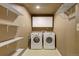 Laundry room featuring a washer, dryer, shelving, and cabinets for storage at 4820 W 125Th Ave, Broomfield, CO 80020