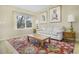 Bright living room featuring a large window, a neutral sofa, and hardwood floors with colorful rug at 4820 W 125Th Ave, Broomfield, CO 80020