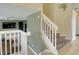 A staircase with carpeted steps and white railing. There is wood style flooring on the landing at 4820 W 125Th Ave, Broomfield, CO 80020