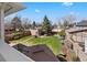 Large backyard with lush lawn, mature trees, landscaping and a fenced perimeter at 4045 E 18Th Ave, Denver, CO 80220