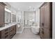Bright bathroom featuring a soaking tub, walk-in shower, double sink vanity and lots of cabinet space at 4045 E 18Th Ave, Denver, CO 80220