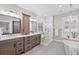Bathroom with double vanity, a freestanding tub, and glass-enclosed shower, showcasing modern fixtures and finishes at 4045 E 18Th Ave, Denver, CO 80220