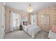 Cozy bedroom with floral wallpaper, plush bedding, and abundant natural light at 4045 E 18Th Ave, Denver, CO 80220