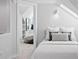 Bright bedroom features a bed with neutral tones, a walk-in closet with shelving, and carpeted floors at 4045 E 18Th Ave, Denver, CO 80220