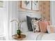 Detailed view of a bedroom's headboard, highlighting decorative pillows and a white orchid on a side table at 4045 E 18Th Ave, Denver, CO 80220