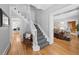 Elegant entryway with a curved staircase, hardwood floors, and views into the living room at 4045 E 18Th Ave, Denver, CO 80220