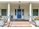 Inviting front porch with white columns, stylish railing, and a bright blue front door with decorative screen at 4045 E 18Th Ave, Denver, CO 80220