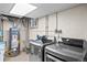 The laundry room with modern washer and dryer units and modern water heater at 4045 E 18Th Ave, Denver, CO 80220