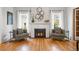 Cozy living room featuring a fireplace, hardwood floors, and stylish decor with bright, natural light at 4045 E 18Th Ave, Denver, CO 80220
