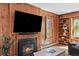 Cozy living room featuring a wood-burning fireplace and built-in bookshelf at 4045 E 18Th Ave, Denver, CO 80220