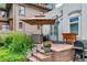 Outdoor patio seating area with an umbrella, barbecue and brick pavers at 4045 E 18Th Ave, Denver, CO 80220