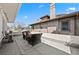 Outdoor patio features a seating area, patterned rug, and brick house with architectural details at 4045 E 18Th Ave, Denver, CO 80220