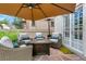 Outdoor patio with comfortable seating, a fire table, and a view of the landscaped backyard at 4045 E 18Th Ave, Denver, CO 80220