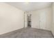 Bedroom with access to upstairs and neutral colored walls at 9255 E Lehigh Ave # 211, Denver, CO 80237