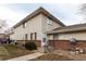 Tan two-story condo building with brick base and landscaping at 9255 E Lehigh Ave # 211, Denver, CO 80237