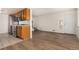 Kitchen with wood cabinets, granite counters, and appliances at 9255 E Lehigh Ave # 211, Denver, CO 80237
