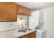 Laundry closet with stacked washer and dryer in kitchen at 9255 E Lehigh Ave # 211, Denver, CO 80237
