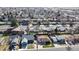An aerial view showcasing a neighborhood with neat rows of houses, mature trees, and well-maintained lawns at 8910 Rutgers St, Westminster, CO 80031