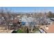 View of a house with a small backyard with a deck, partially obscured by trees from an elevated angle at 8910 Rutgers St, Westminster, CO 80031