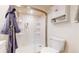 Bright bathroom featuring a glass enclosed shower and linen storage at 8910 Rutgers St, Westminster, CO 80031