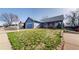 Charming blue home featuring an attached garage and well-manicured front lawn and a red front door at 8910 Rutgers St, Westminster, CO 80031