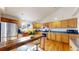 Well-lit kitchen with wooden cabinets, stainless steel appliances, and a breakfast bar with seating at 8910 Rutgers St, Westminster, CO 80031
