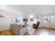 Cozy living room with hardwood floors, a gray sofa, and a wall-mounted TV at 8910 Rutgers St, Westminster, CO 80031