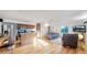 Open-concept living room with stainless steel appliances, kitchen island, and hardwood floors at 8910 Rutgers St, Westminster, CO 80031